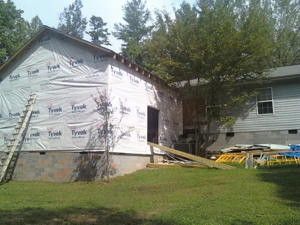 Tyvek wrapped gable on a new room addition beside an existing home in Shirley