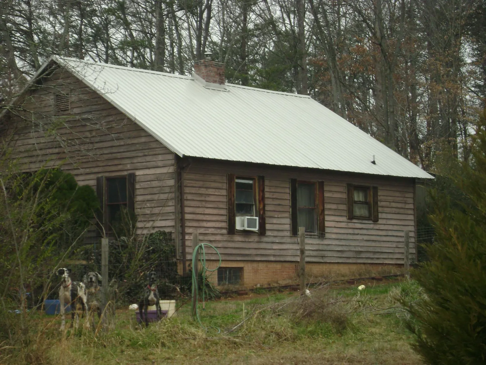 White metal roof on an old wood sided farmhouse, from a Metal Roof Installation job in Shirley